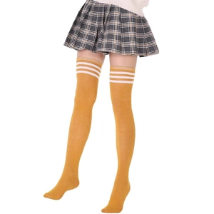 Close-up of yellow knit over-the-knee socks with three white stripes in academy style