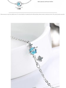 Macro view of blue planet charm bracelet with 10mm glass bead and silver star details