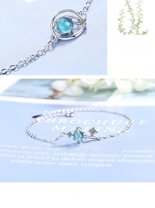 Macro shot of silver planetary bracelet with a translucent blue star stone and zircons