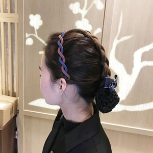 Matte braided candy color headband in blue and reddish brown worn by a model