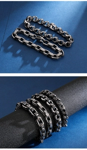 Detail of retro punk skull bracelet and geometric engraved chain in antique silver finish