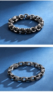 Detailed view of punk style silver and black skull chain bracelets for men on blue background