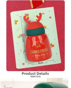 Close-up of a Christmas thermos featuring 3D red reindeer antlers and gold elk pattern