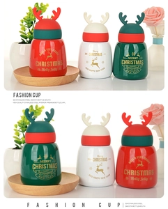 Three colorful Christmas reindeer mugs made of 304 stainless steel in festive home setting