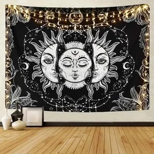 Detail of bohemian sun moon tapestry with warm fairy lights in a cozy room setting