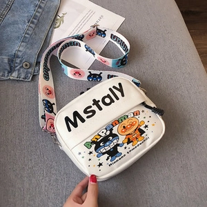 Close-up of white mini crossbody bag featuring Anpanman character and adjustable strap