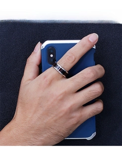 Men's modern stainless steel ring with black inlay stripe shown on finger with phone