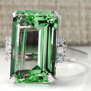 Emerald cut green zircon engagement ring in platinum plated copper with side stones