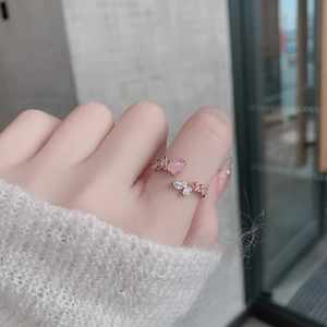 Close-up of rose gold adjustable ring with pink pear-cut crystal and white zircon stones