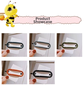 Close-up of sleek acrylic oval hair clips in five colors on display cards