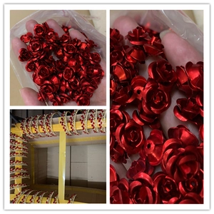 Detailed close-up of red rose-shaped beads and golden bridal crowns with red crystals