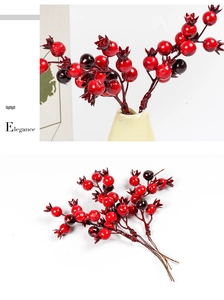Detailed view of artificial red pomegranate berry stems for DIY Christmas wreaths and decor