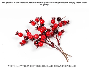 Detail of red artificial berry branches with glossy multi-toned fruits for DIY Christmas decor