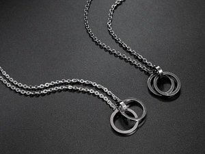 Detailed macro shot showing the metallic luster of intertwined silver rings necklaces