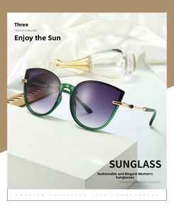 Detail of cat eye sunglasses with green translucent frames and purple gradient lenses