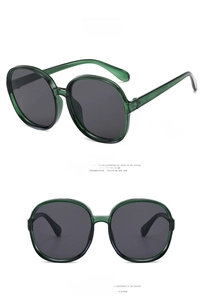 Macro view of transparent emerald green oversized sunglasses with grey tinted lenses