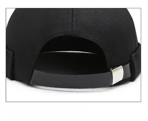 Detail of adjustable leather strap and silver buckle on black brimless docker hat