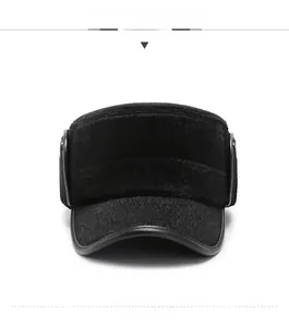 Close-up of black plush winter hat featuring ear protection and silver metal N detail