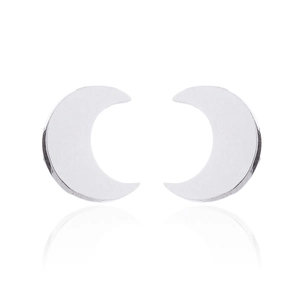 Macro shot of silver crescent moon stud earrings showing polished metal surface and reflection