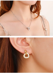 Detailed close-up of diamond-studded heart necklace and matching earrings set