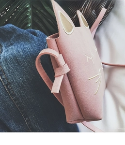 Detail of pink cat-themed mini shoulder bag with embroidered whiskers and 3D ears