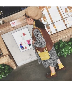 Side view of a little girl wearing a cute yellow cat crossbody bag with 3D ears