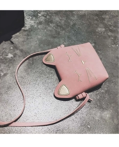 Detail shot of a pink cat-shaped girls' crossbody bag with 3D ears and embroidery