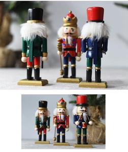 Detailed close-up of three 15cm wooden nutcracker soldiers with festive gold accents