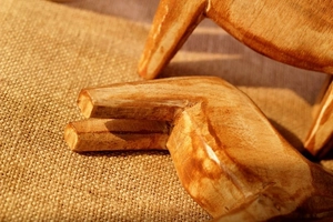 Macro detail of hand-carved Dala horse showing natural wood grain and polished finish