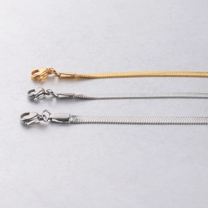 Detailed view of gold and silver stainless steel herringbone chains in three sizes