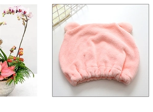 Detail of pink microfiber hair towel with cute bear ears and elastic band for fast drying