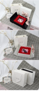 Detail of double-door rose gift box with jewelry slot and matching paper bag