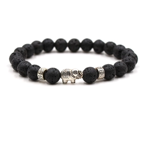 Black lava rock beaded bracelet featuring a vintage silver elephant charm and carved spacers