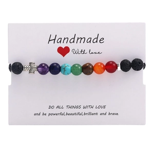 Handmade 7 chakra natural stone bead bracelet with a silver cross on a display card