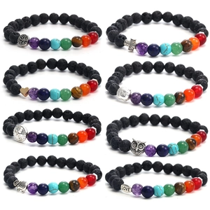 Detailed set of 8 chakra lava rock bracelets with various silver charms on white background