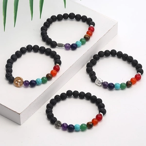 Detailed shot of four beaded lava stone bracelets with life tree and Buddha pendants