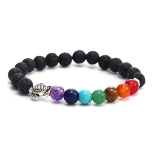 Detail of 7 chakra stones bracelet with black volcanic beads and silver turtle charm