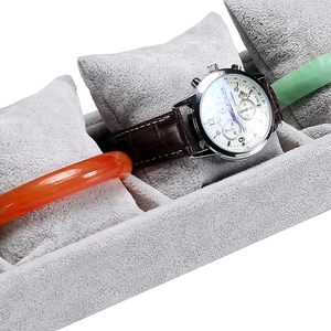 Gray velvet watch display tray with soft pillow inserts for bracelet storage