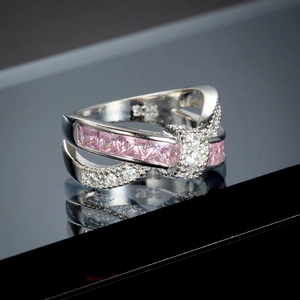 Macro shot of S925 sterling silver ring with cross design and pink square zircon