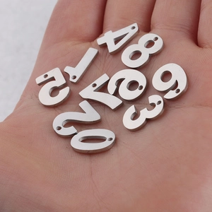 Polished silver stainless steel 0-9 number pendants for DIY jewelry held in hand