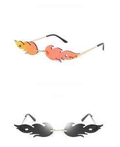 Close-up of flame-shaped rimless sunglasses in orange gradient and grey with metal temples