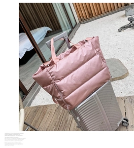 Pink quilted fitness bag with suitcase sleeve handle strap for easy travel storage