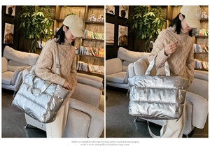 Close-up of a silver puffer tote bag shown on model in a casual lifestyle setting