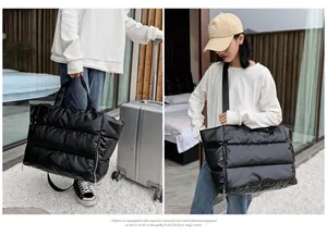 Detail of black quilted fitness bag showing travel use and shoulder carry style