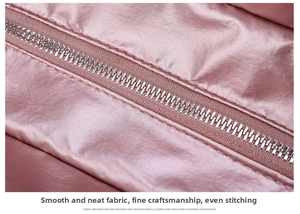 Detail of metal zipper on pink gym bag with high-density stitching and satin finish