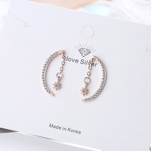Rose gold moon and star stud earrings with white zircon on jewelry card
