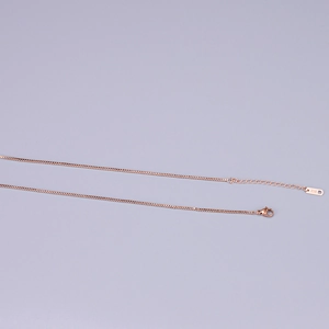 Detail of rose gold box chain necklace with lobster clasp and K18 hallmark tag