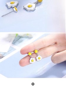 Detail of creative fried egg drop earrings showing high-quality enamel and silver studs
