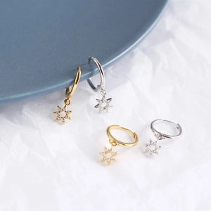 Macro detail of S925 sterling silver hexagonal star hoop earrings with sparkling crystals