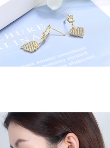 Detail of golden heart knot earrings with micro-set diamonds shown on model